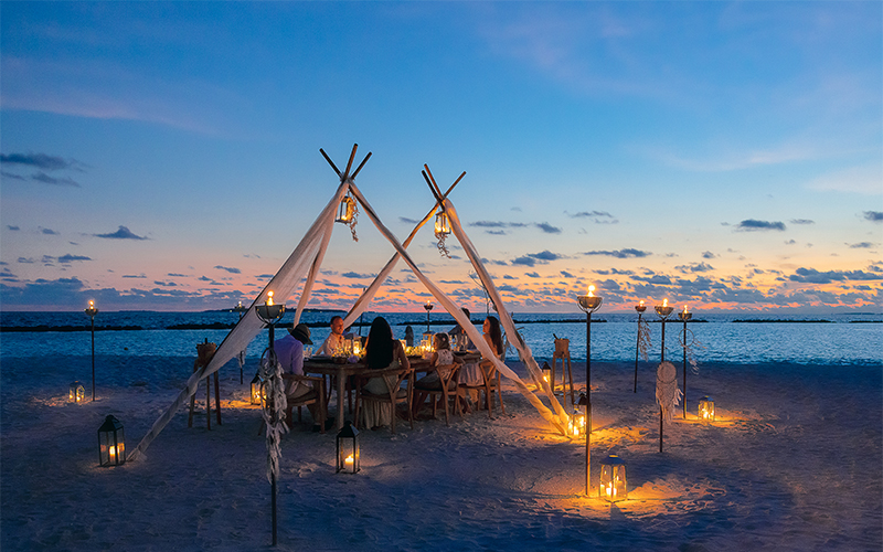 Private dining setup on the beach at The Nautilus Maldives