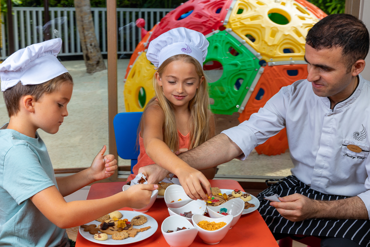 Kids decorating cookies at the Young Wonderers club